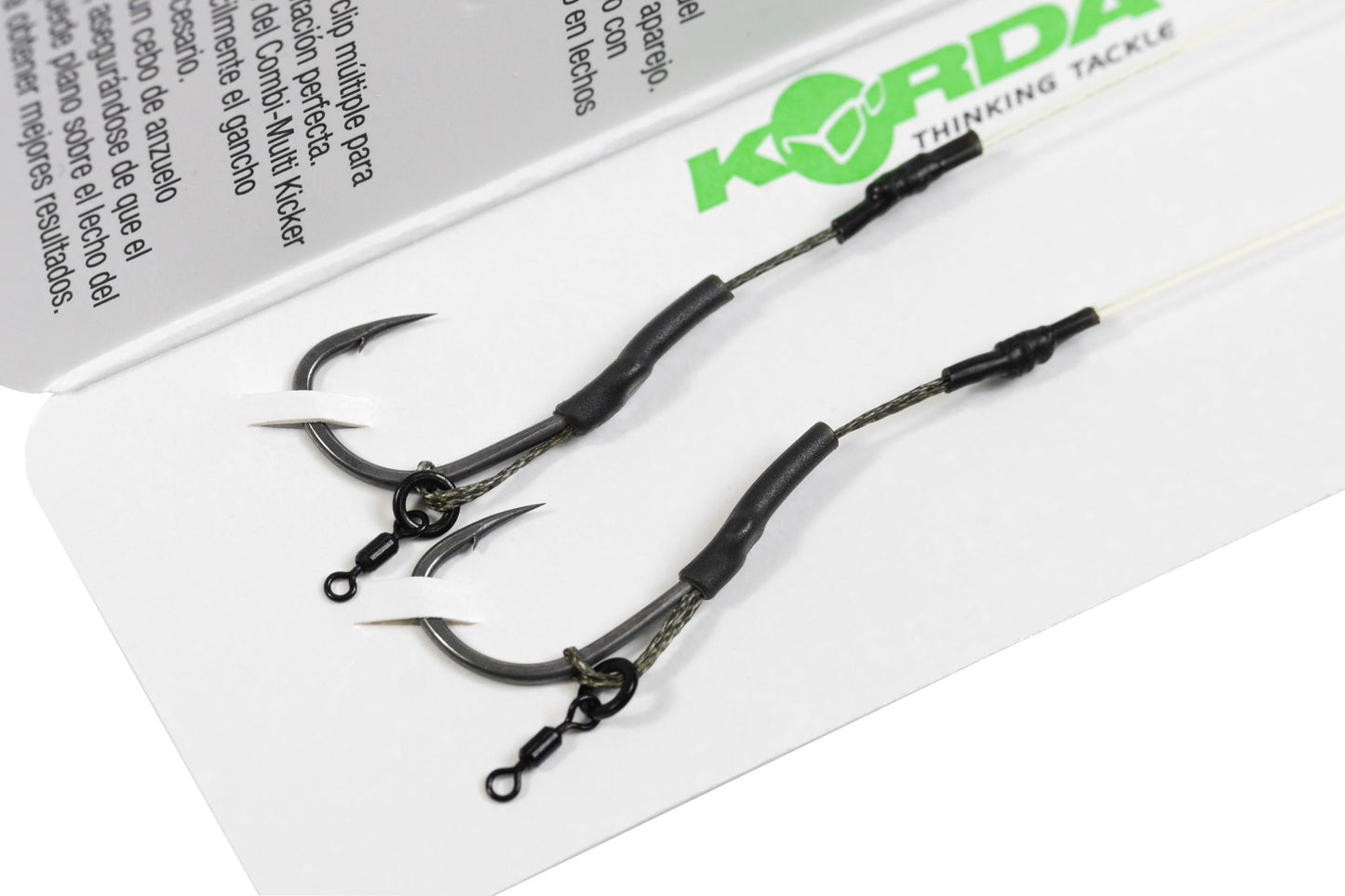 Two fishing hooks on a white surface with Korda branding.