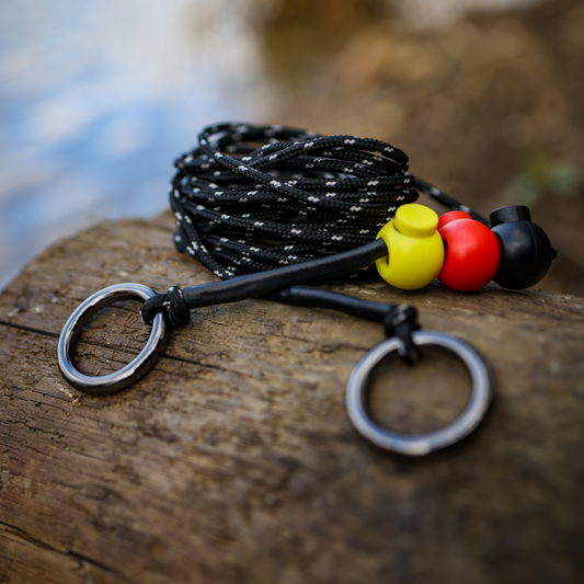 Fishing line with markers and rings on a wooden surface